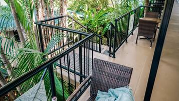 Relax in a serene garden setting with a dining area surrounded by lush greenery.