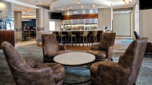 A lobby with a bar area, seating, and a television screen. - Courtyard by Marriott San Antonio SeaWorld - Westover Hills (San Antonio)