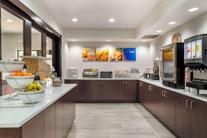 Una cocina moderna con una isla central, equipada con microondas, tostadora y cafetera.