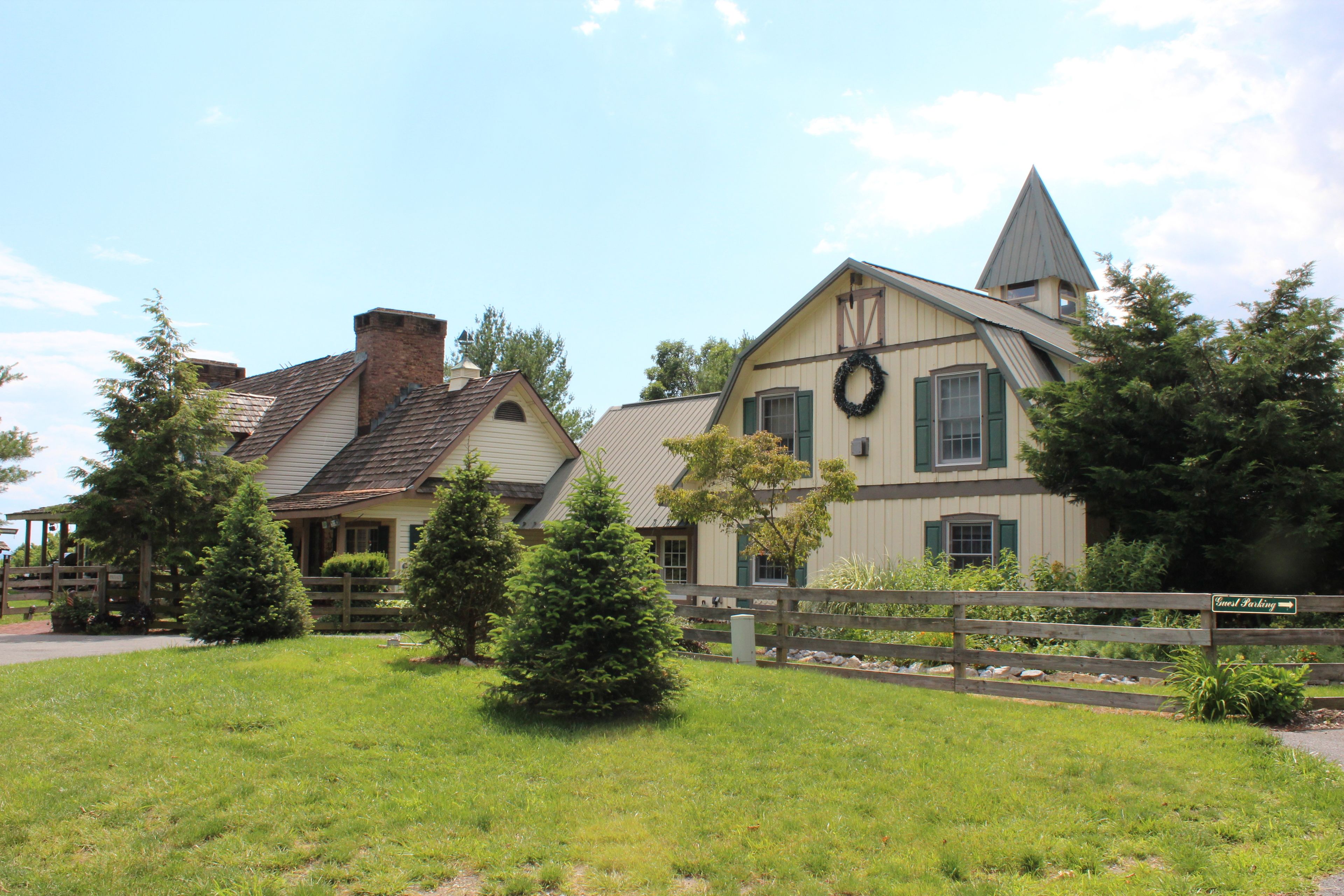 A large, two-story building with a prominent tower and a wreath on the front.