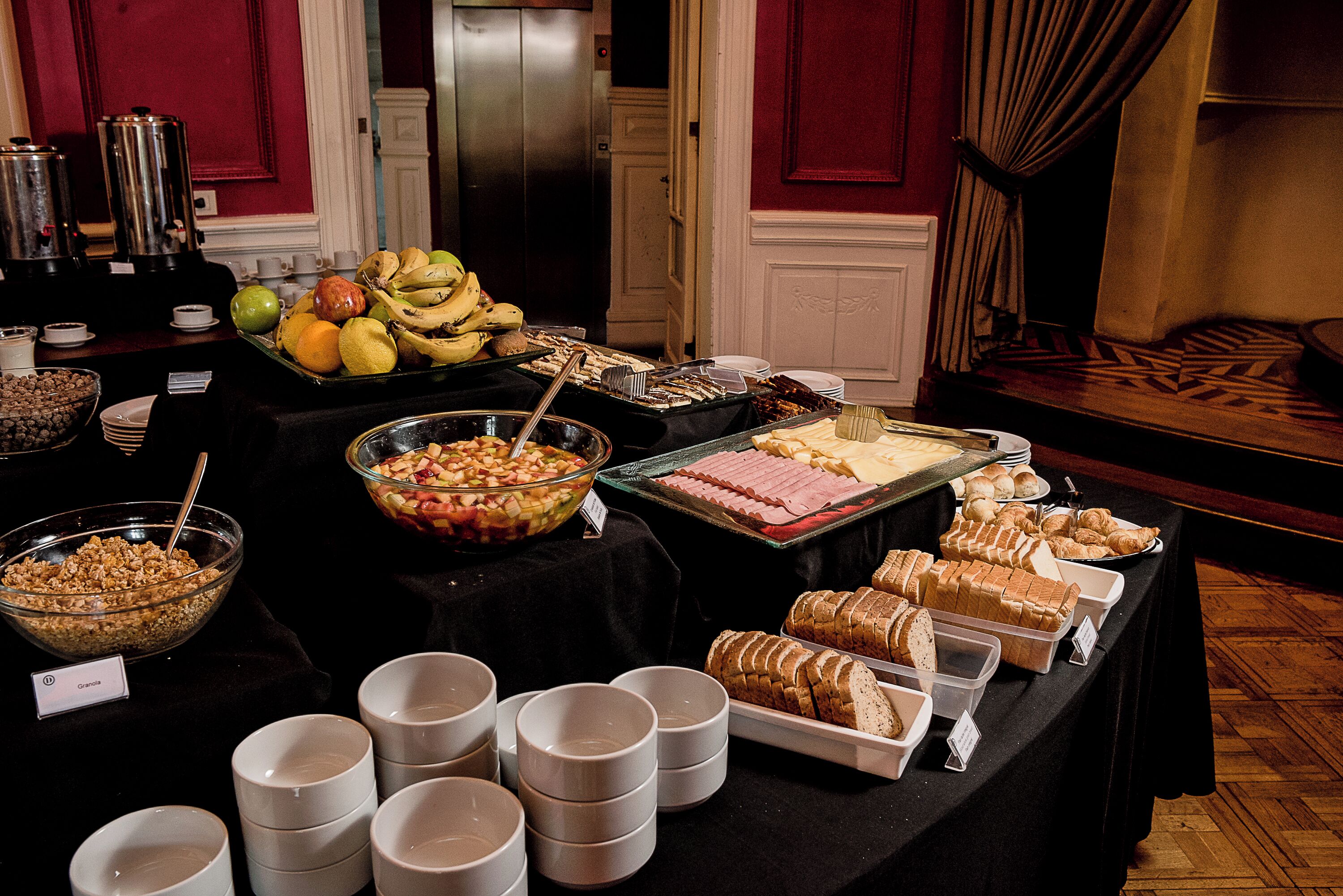 A buffet table with various food items and serving dishes.