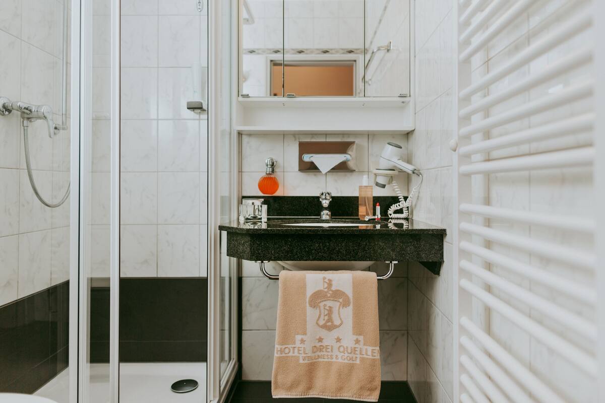 shower, hair dryer, bathrobes, slippers