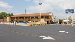 A motel with a swimming pool, a covered parking area, and a sign for Andrew Johnson Inn. - Andrew Johnson Inn (Greeneville)