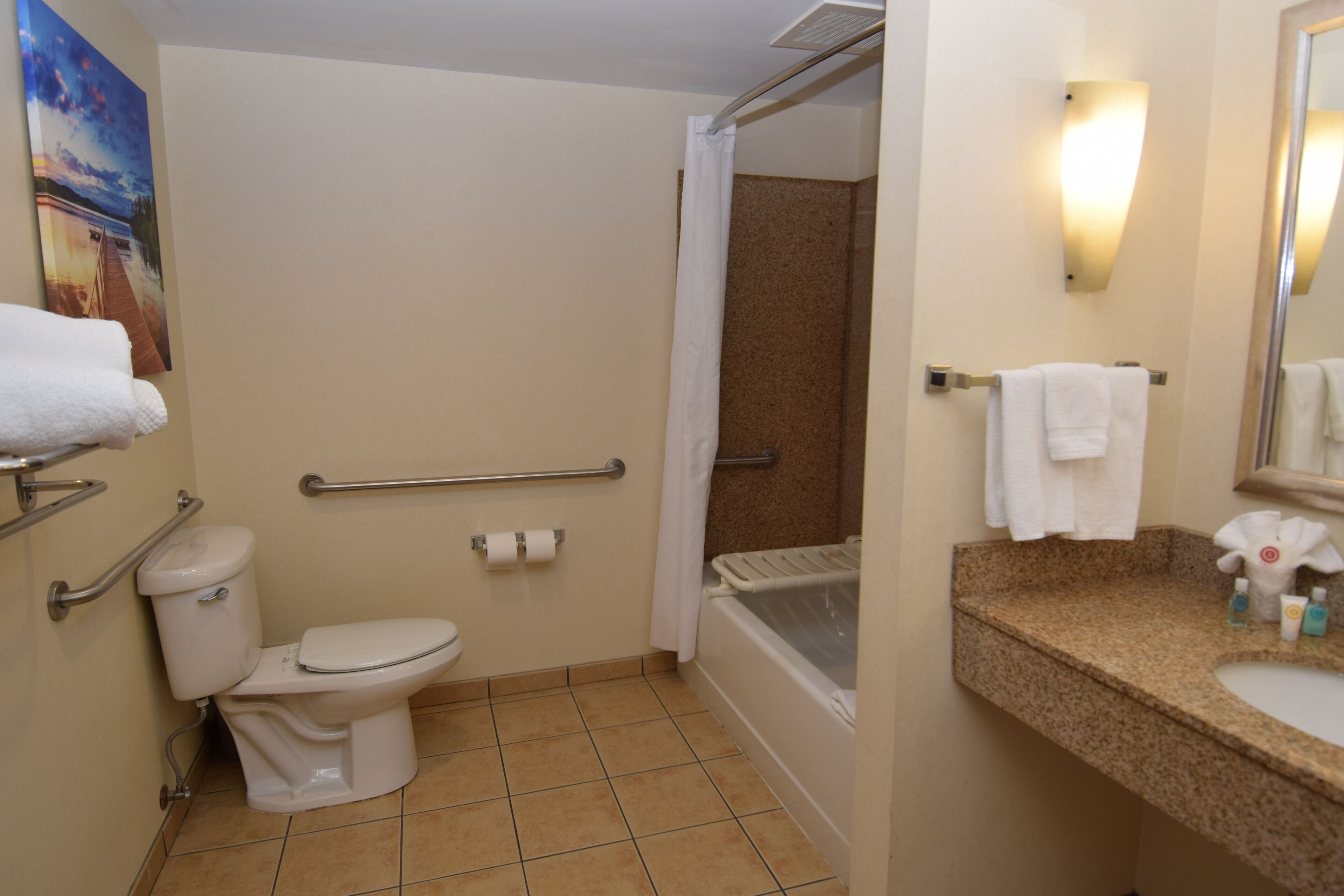 A bathroom with a toilet, shower, and sink.
