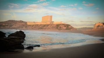 On the beach, surfing