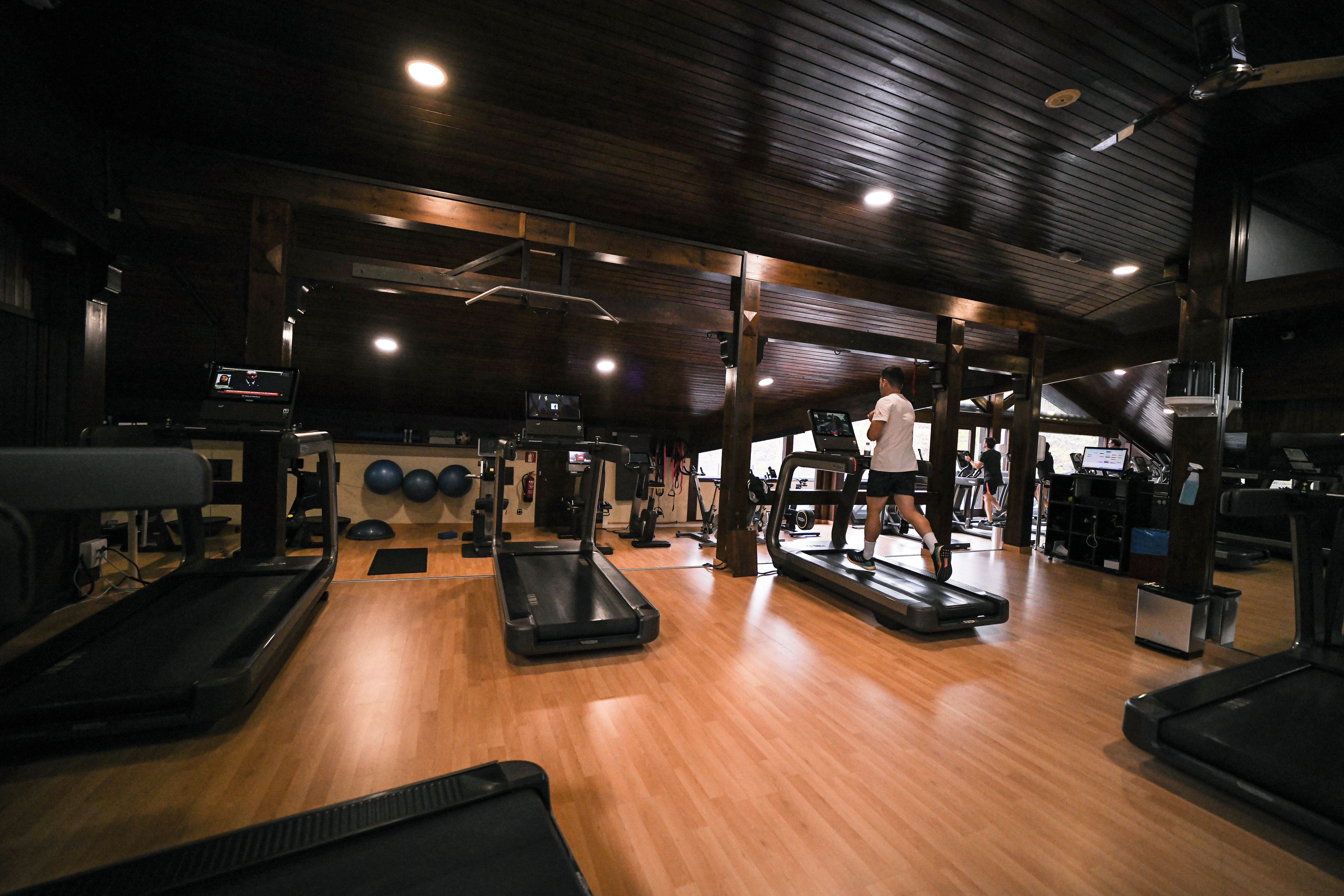 A gym with treadmills, exercise balls, and weight machines.