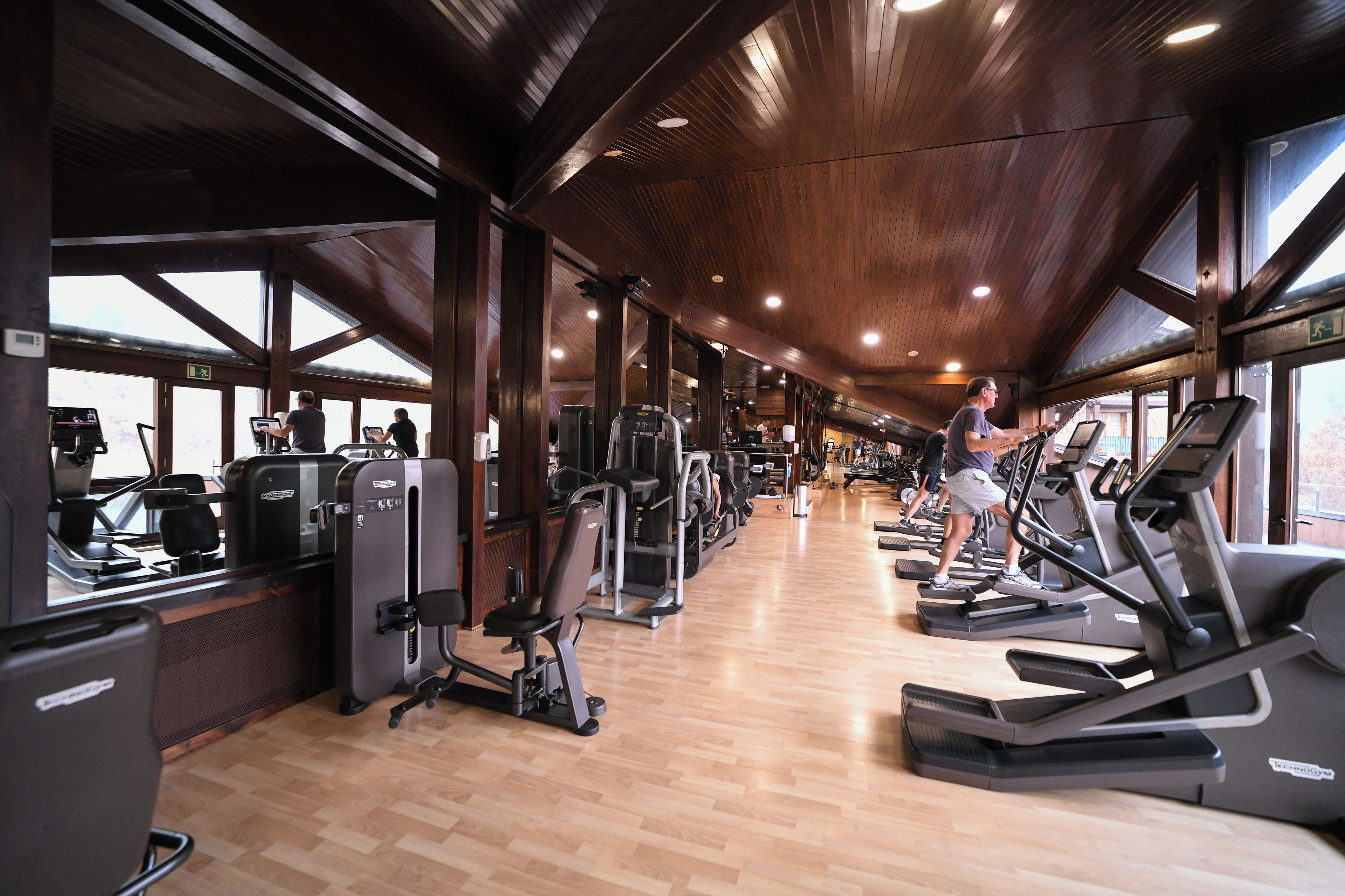 A gym with treadmills, weight machines, and exercise equipment.