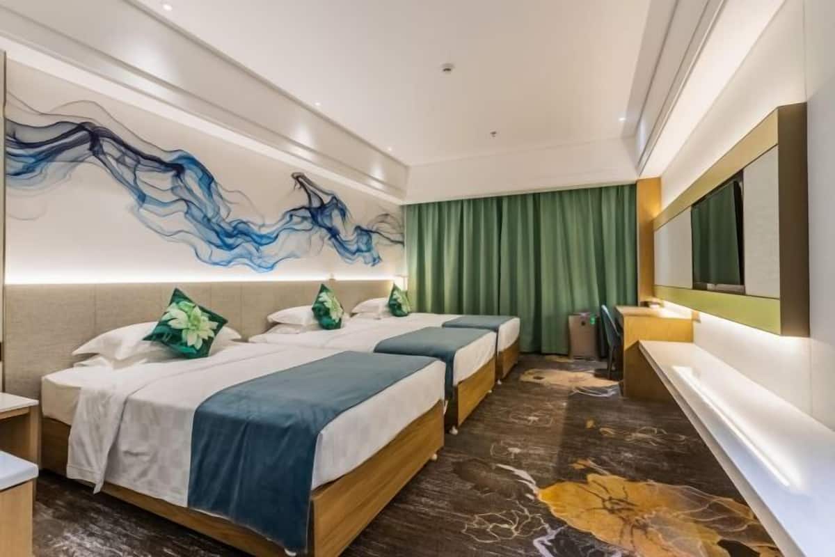 A hotel room with two beds, a large abstract painting on the wall, a green curtain, a reception desk, and a marble-patterned floor.
