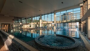 An indoor swimming pool with a hot tub, large windows, and a tiled floor. - Eurostars Queen of Montenegro (Becici)
