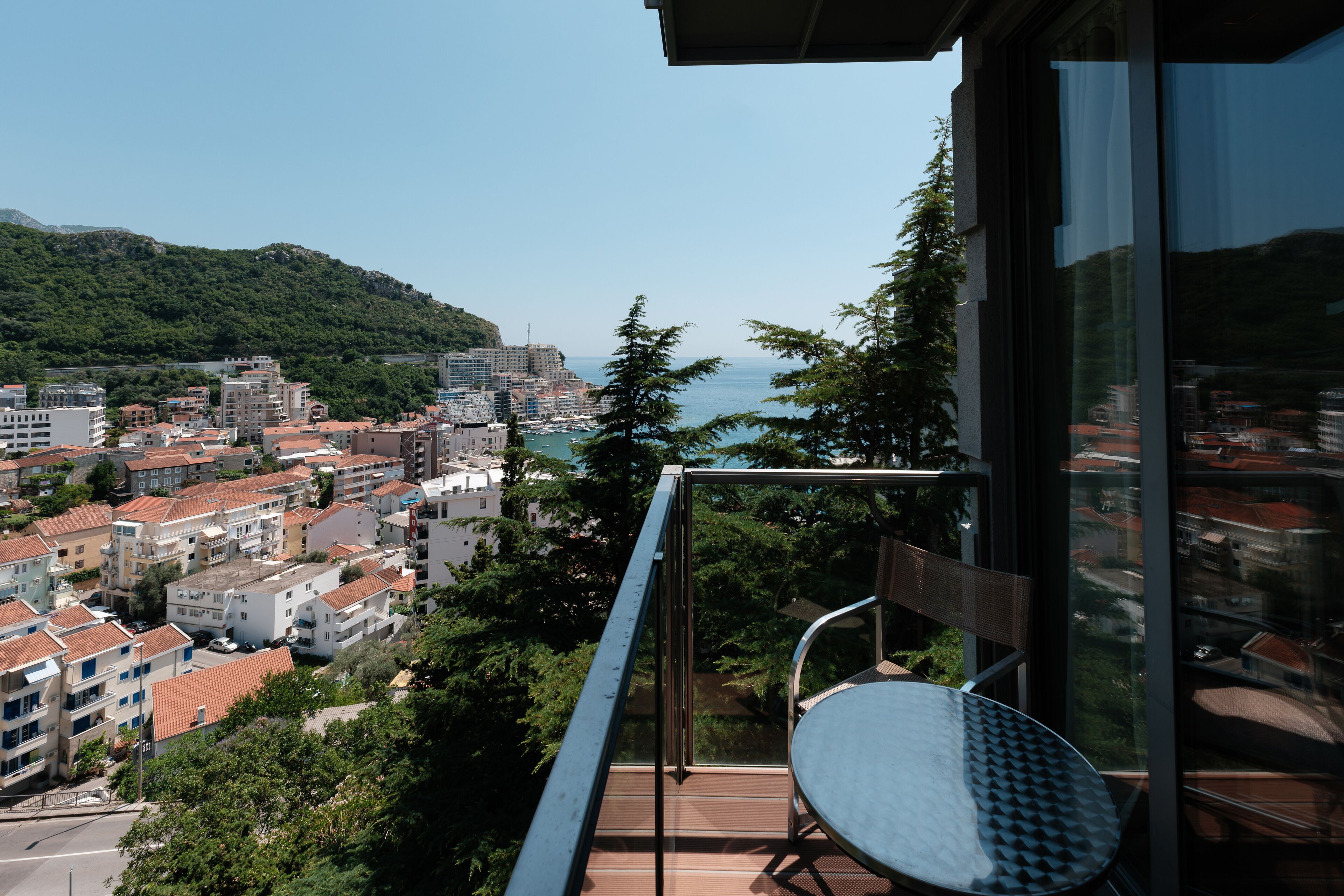 Varanda com vista para um horizonte costeiro, incluindo edifícios e um corpo d'água.