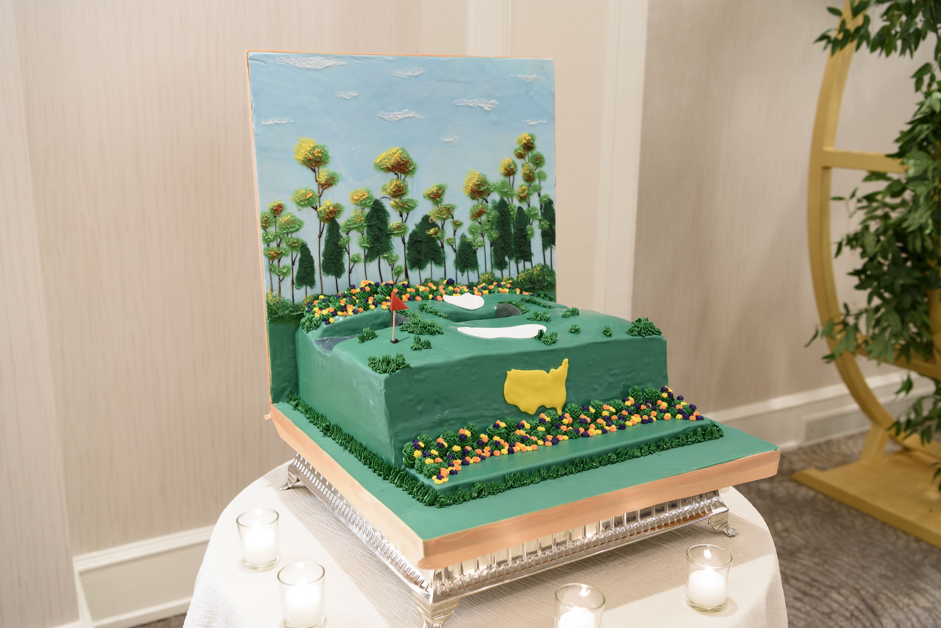 A cake with a green landscape design, including trees and a golf hole.