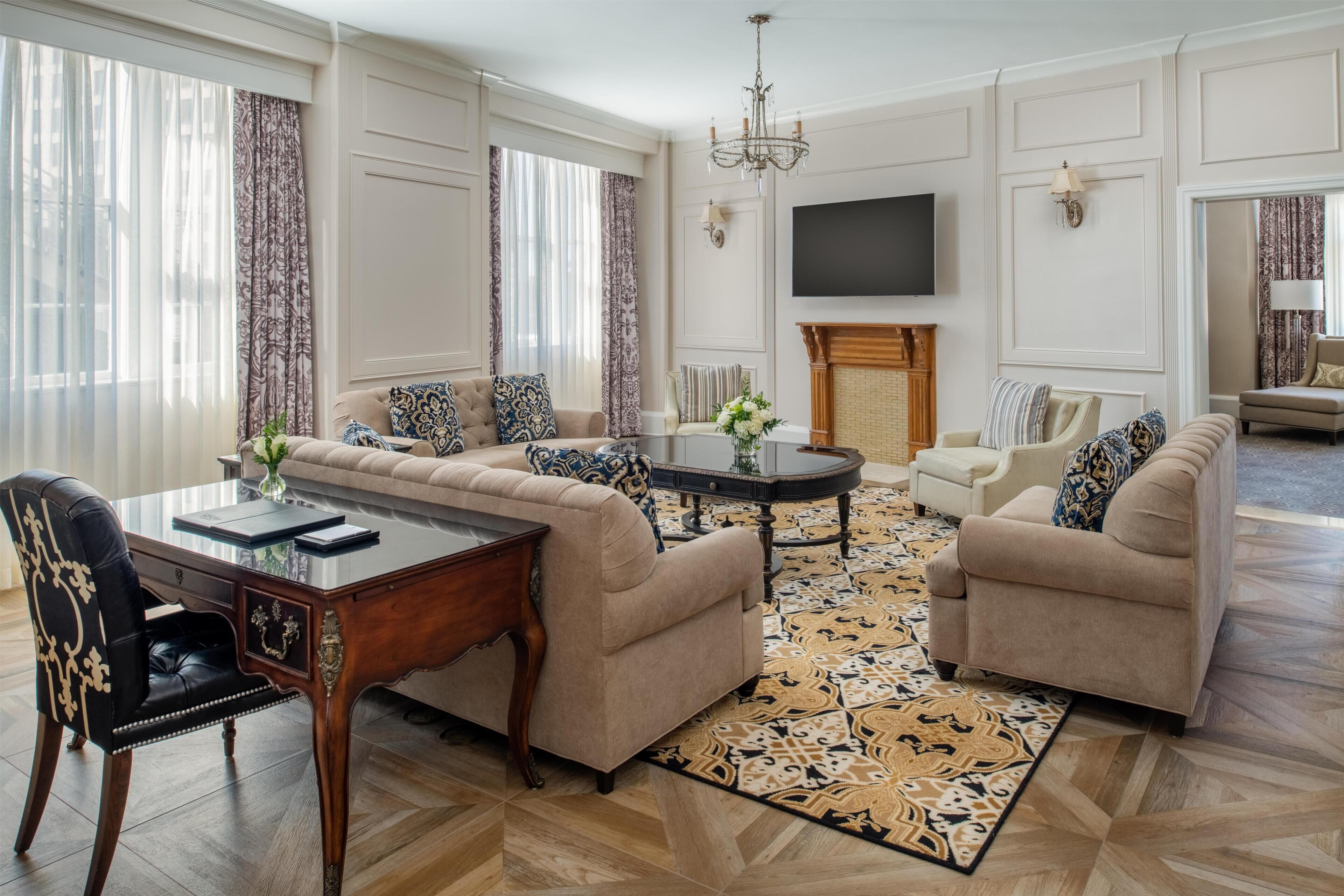 A living room with a sofa set, a coffee table, a TV, and a fireplace.
