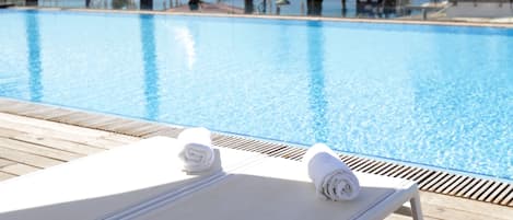 Outdoor pool, open 8 AM to 6 PM, pool umbrellas, pool loungers