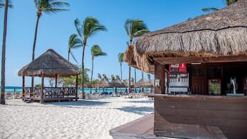On the beach, white sand, sun-loungers, beach umbrellas