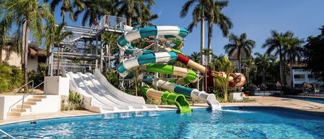 A water park with multiple slides and a pool.