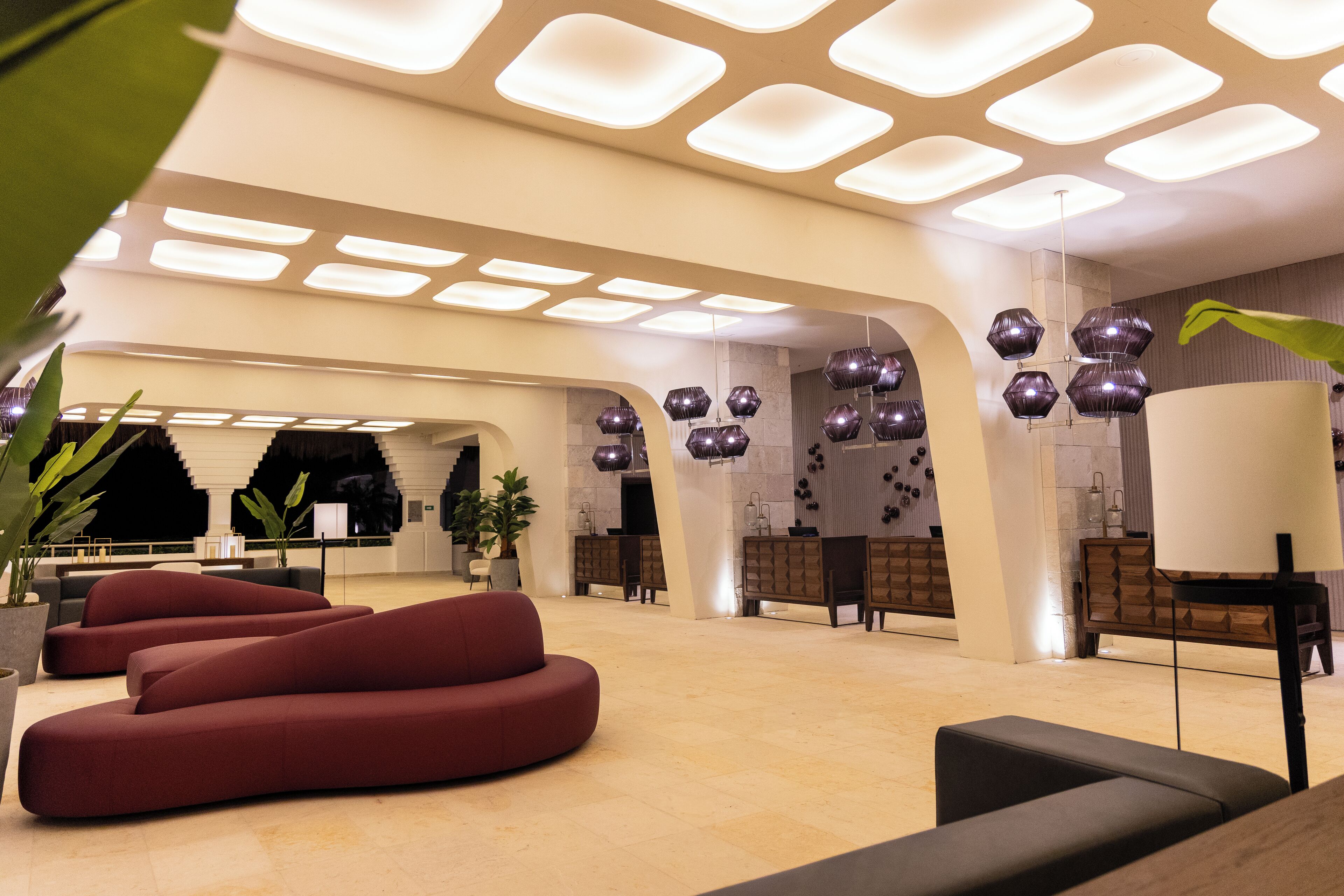A spacious lobby with modern seating, a large chandelier, and a clean, contemporary design.