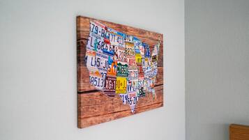 A wall-mounted artwork featuring a map of the United States with state-specific license plates.