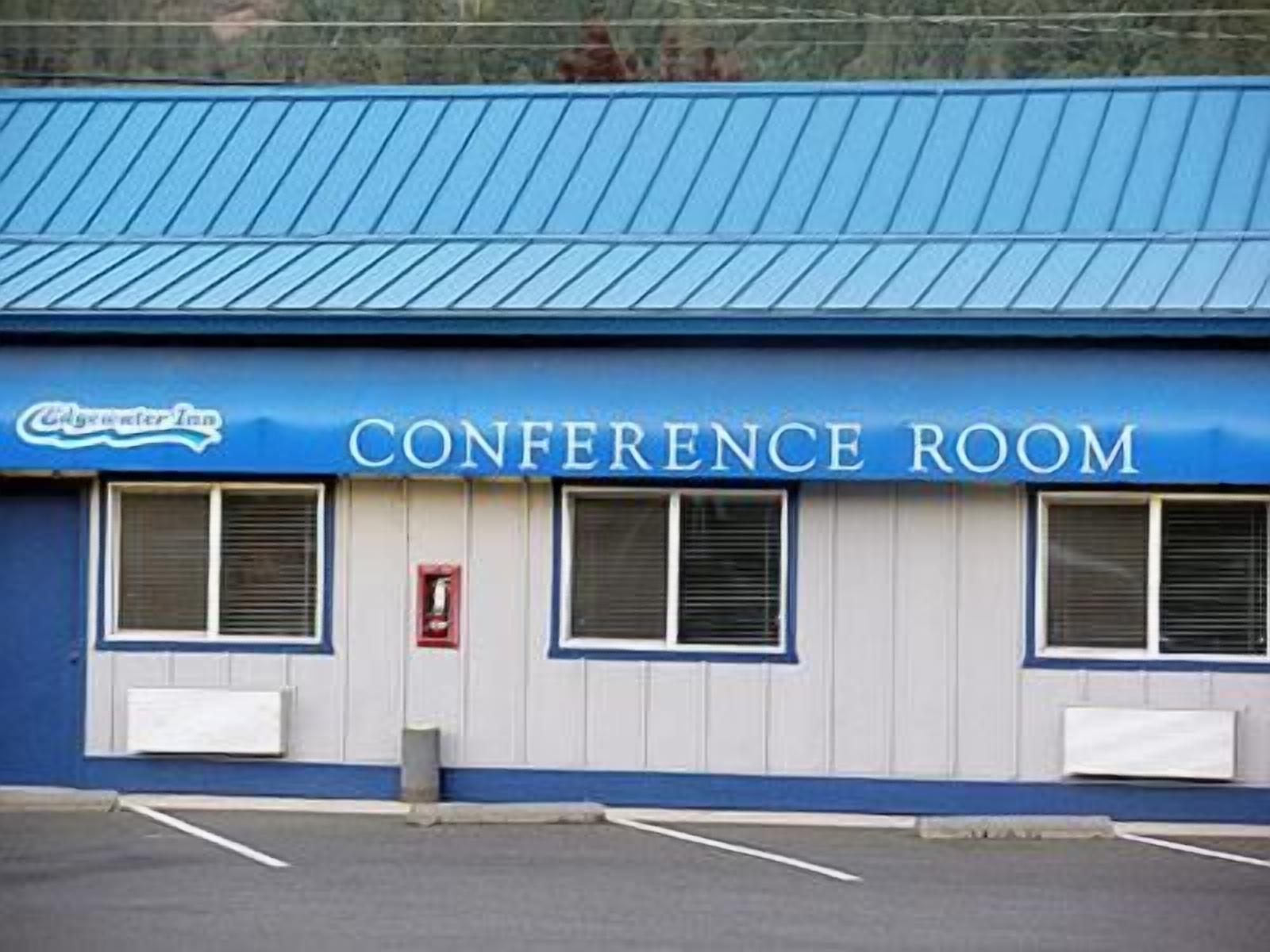 A building with a blue roof and a sign that reads 'CONFERENCE ROOM.'