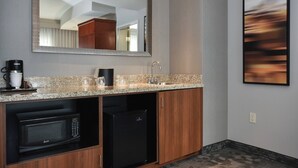 A kitchenette with a microwave, refrigerator, coffee maker, and a sink. - Courtyard Marriott Concord (Concord)