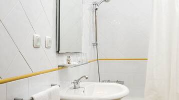 A bathroom with a white sink, mirror, and shower. Yellow lines are on the floor and walls.