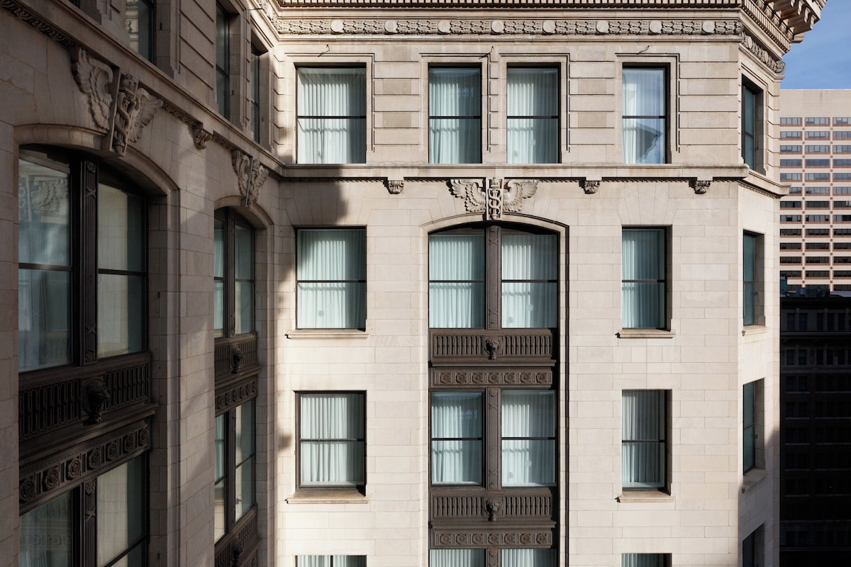 A multi-story building with large windows and decorative architectural details.