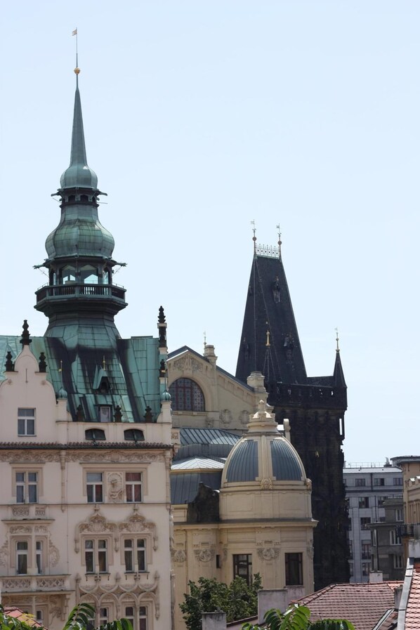 A historic building with a prominent tower and dome, surrounded by other structures.