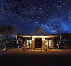 A tented accommodation with a view of the night sky, including stars and the Milky Way. - Desert Nights Resort (Bidiya)