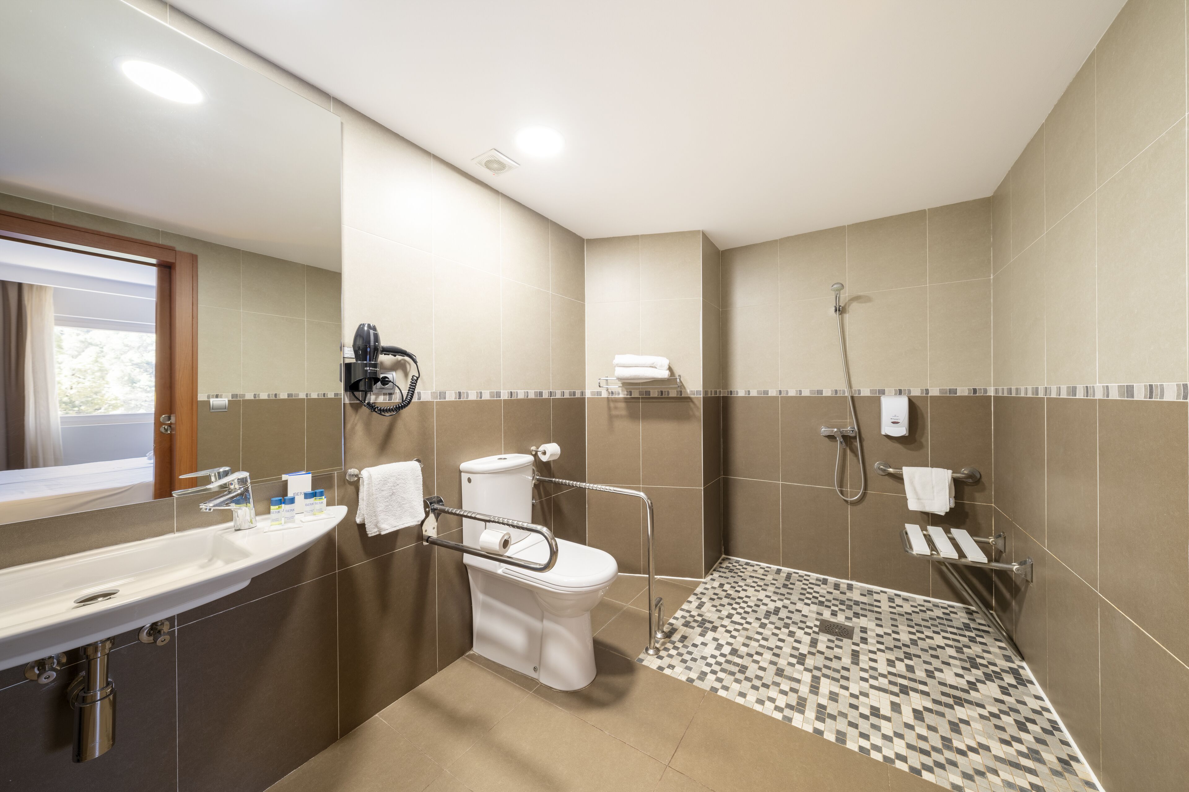 A modern bathroom with a sink, toilet, and shower.