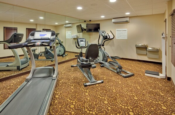A fitness center with treadmills, an elliptical, and a stationary bike.