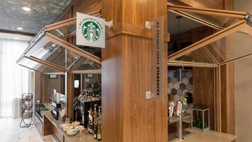 A modern Starbucks with a wooden interior and a glass display case.