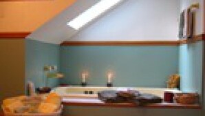 A room with a sloped ceiling, a window with a view, a sink, and a bowl of fruit on the counter. - Beautiful Valley Guesthouse (Scottsville)