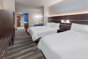 A hotel room with two beds, a desk, a chair, a nightstand, and a kitchenette in the background. - Holiday Inn Express Picayune-Stennis Space Center by IHG (Picayune)