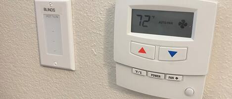 A thermostat with a digital display indicating 72°F and an auto fan setting.