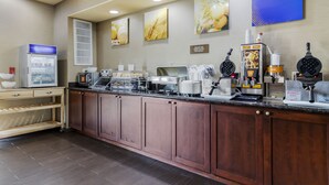 A breakfast bar with waffle makers, a coffee machine, and a refrigerator. - Comfort Suites Pflugerville - Austin North (Pflugerville)