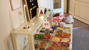 A breakfast buffet with various food items and a signboard. - Hotell Stella (Uppsala)