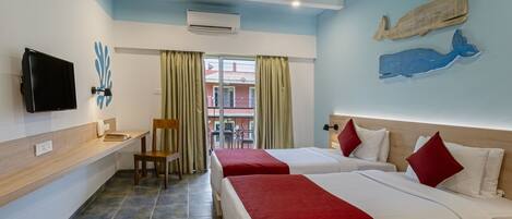 A hotel room with two beds, a desk, a chair, a TV, and a balcony view.