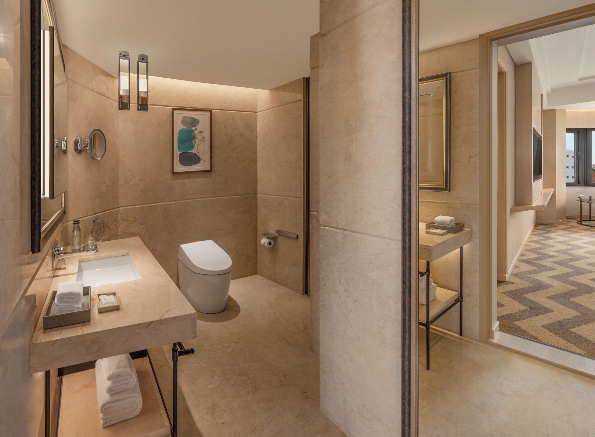 A modern bathroom with a marble sink, a toilet, and a shower area.