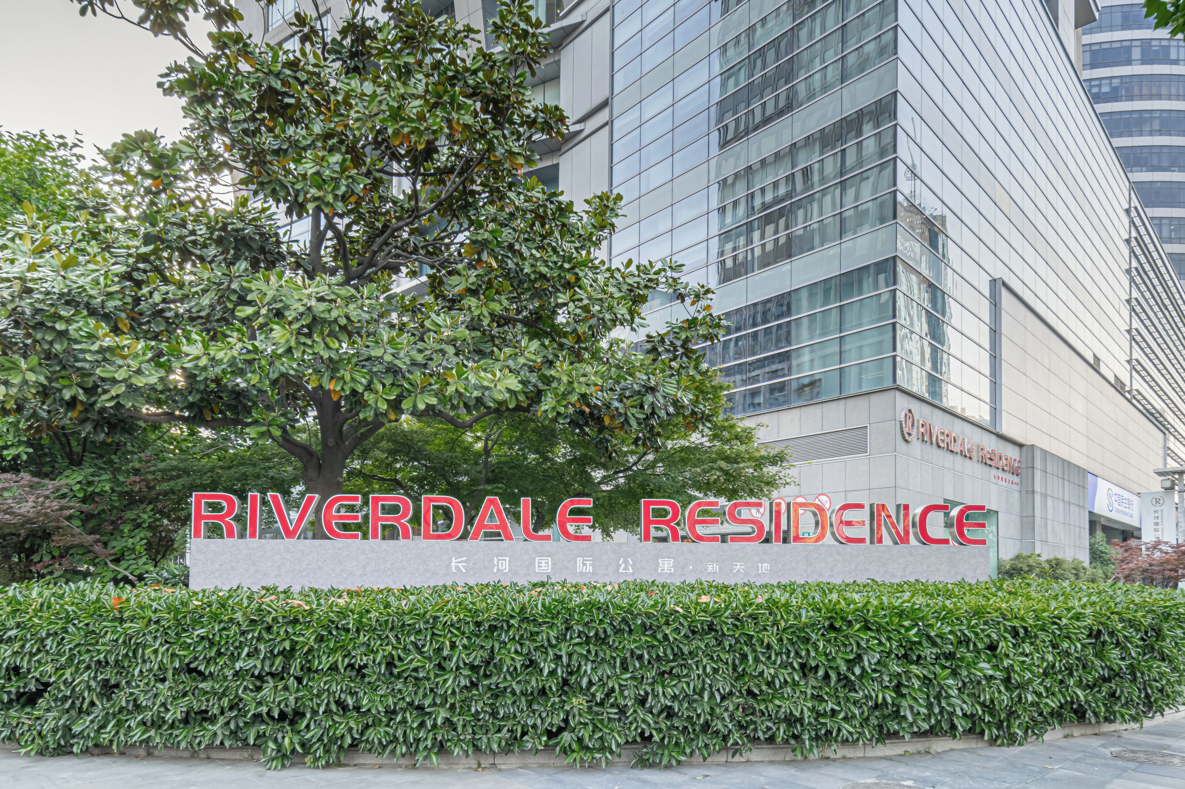 Um edifício com uma placa que diz 'Riverdale Residence'.