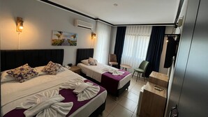 A hotel room with two beds, a desk, a chair, and a small table. - Hotel Lunay (Konyaalti)