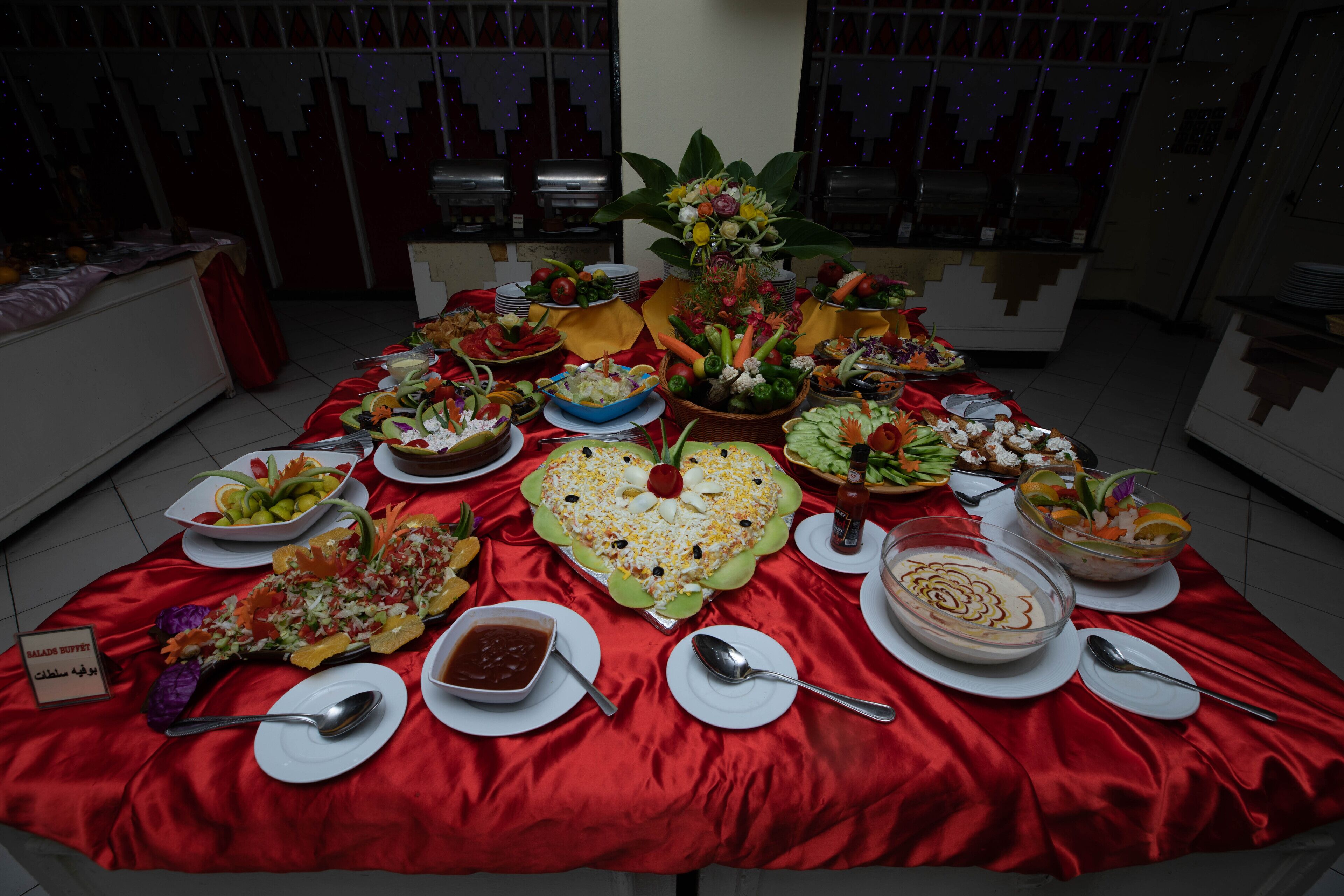 A buffet table with various dishes and a sign indicating a salad buffet.