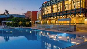 A hotel with a swimming pool, lounge chairs, and a spa indicated by signage. - Polat Thermal Hotel (Denizli)