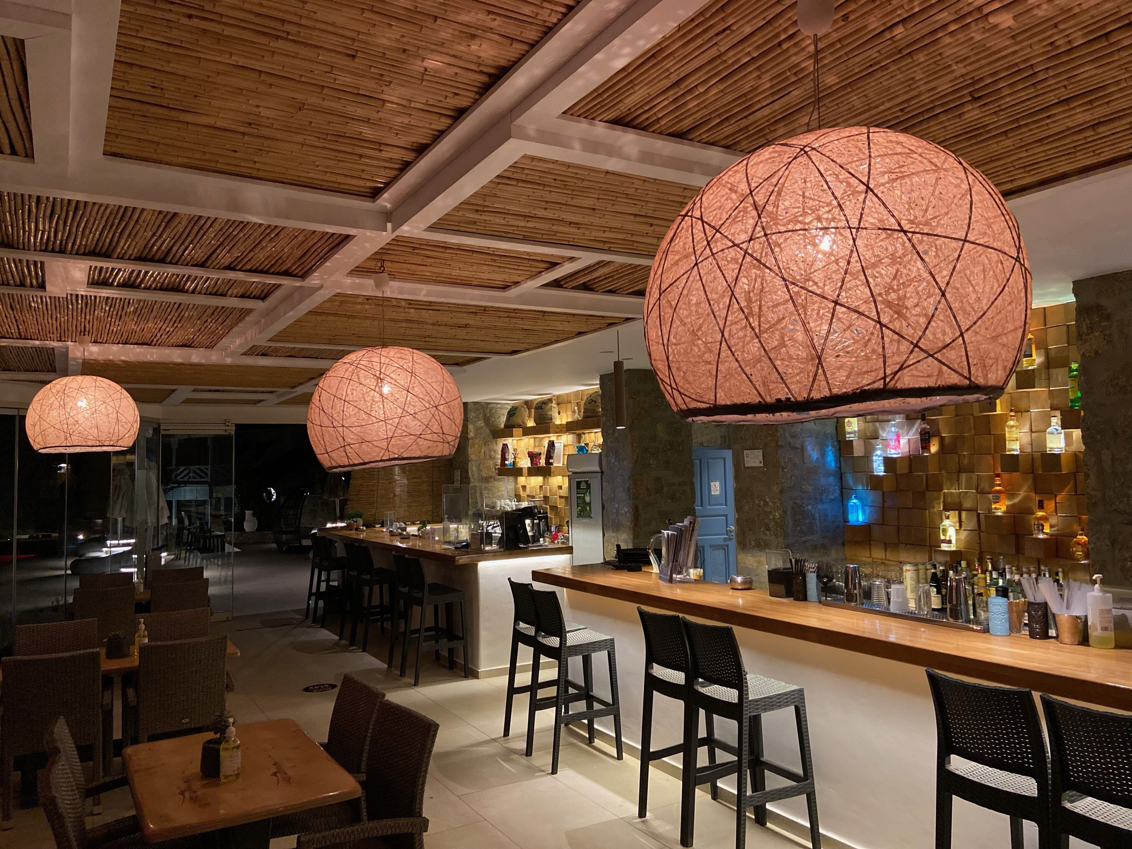 A bar area with a wooden counter and seating.