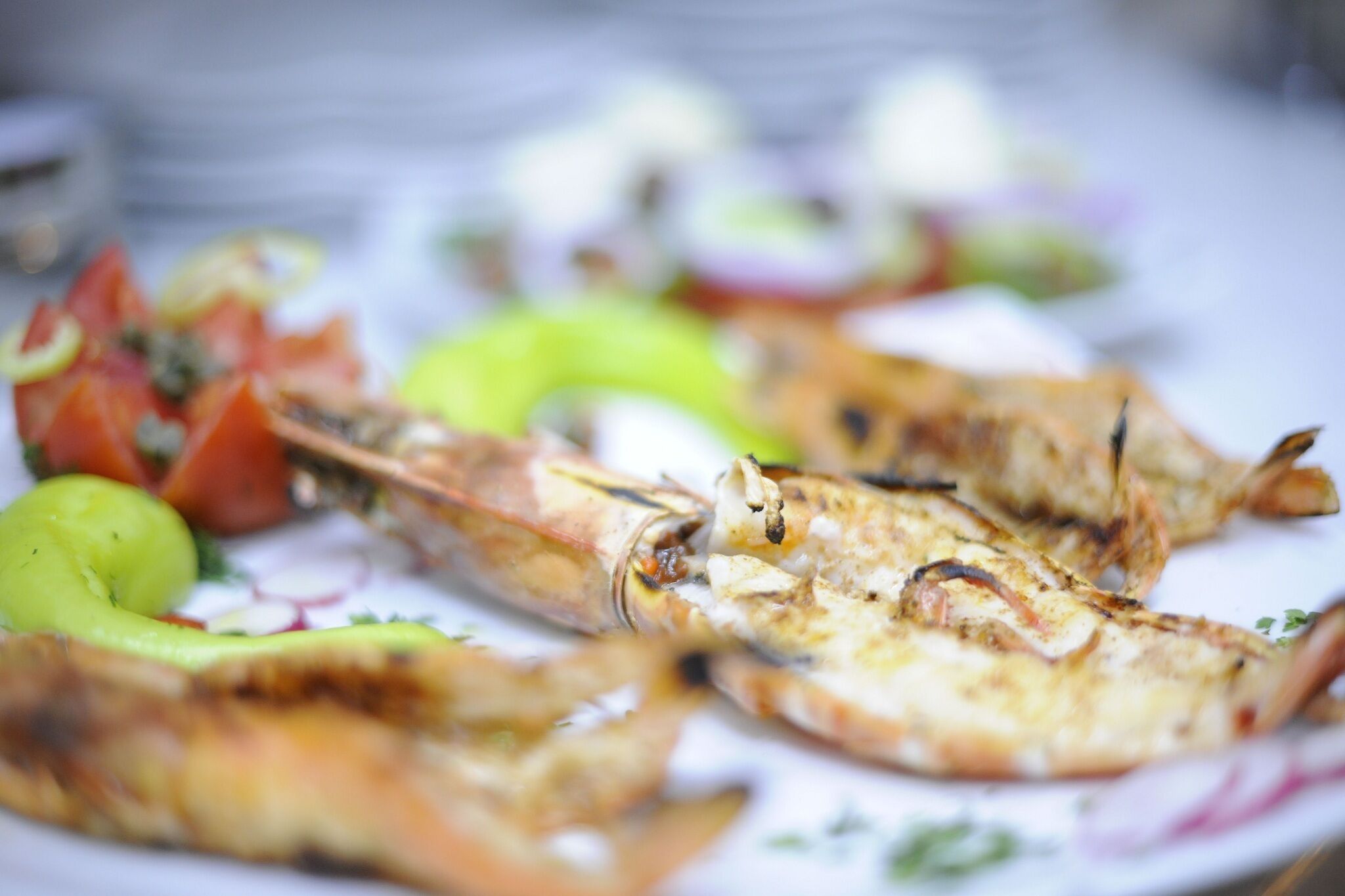 Grilled seafood with vegetables on a plate.