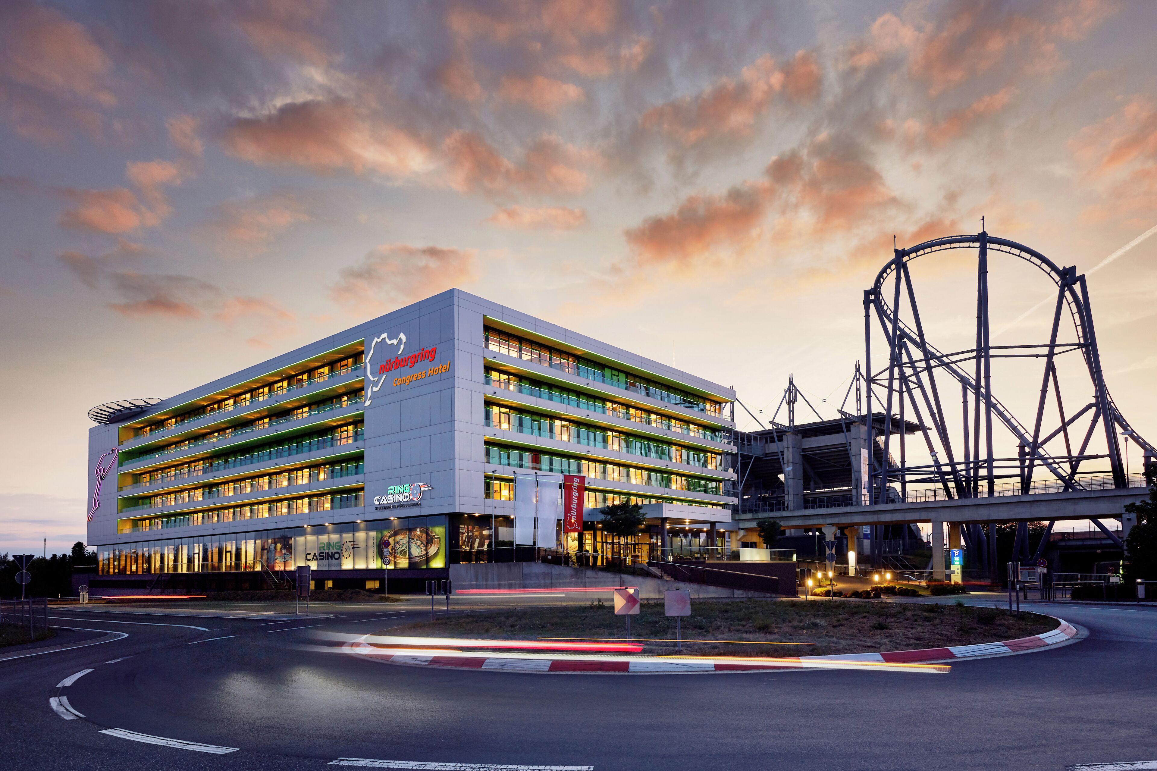 A multi-story hotel with a casino, a Ferris wheel, and a modern architectural design.