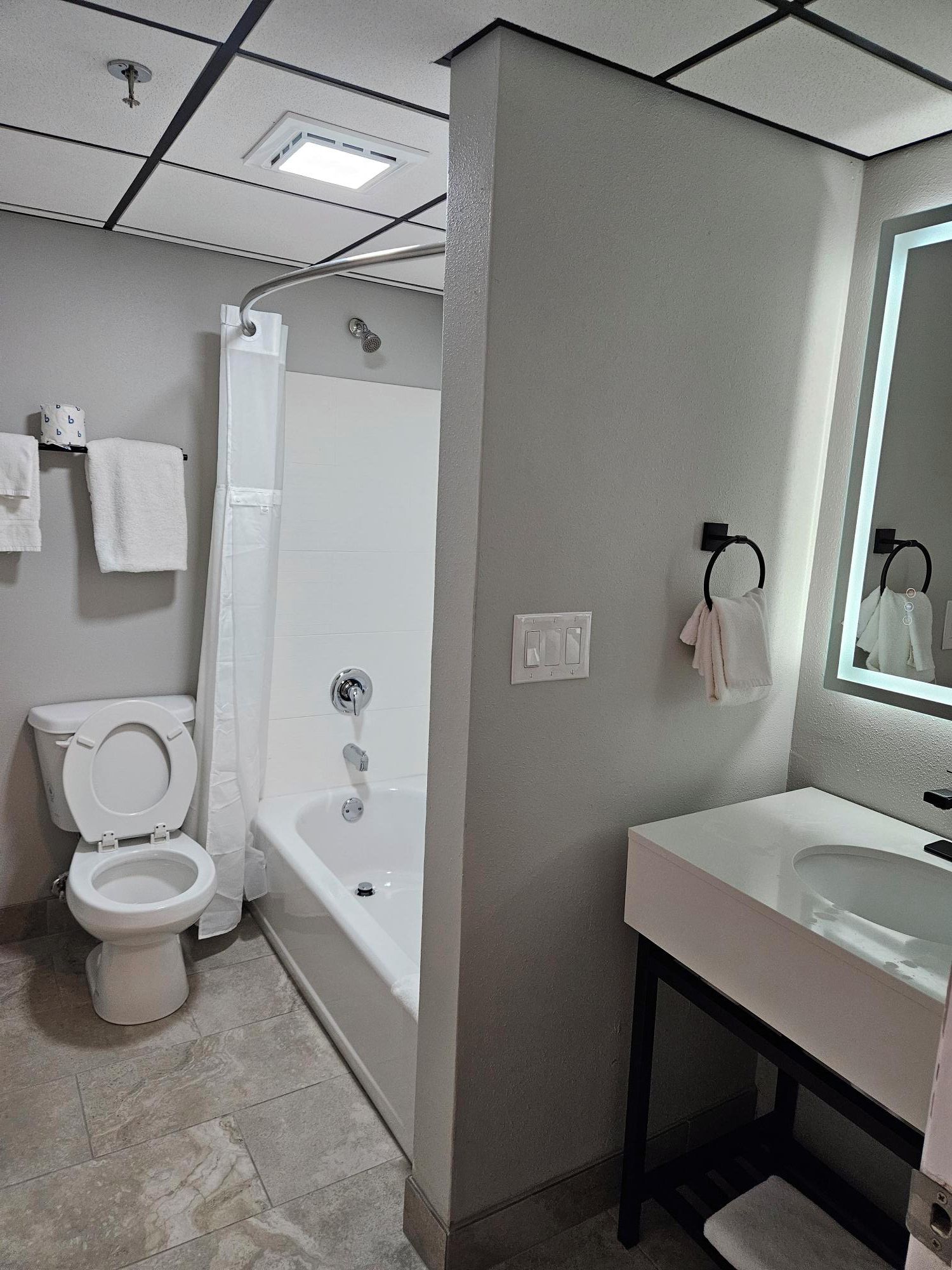 A bathroom with a toilet, shower, bathtub, and sink.