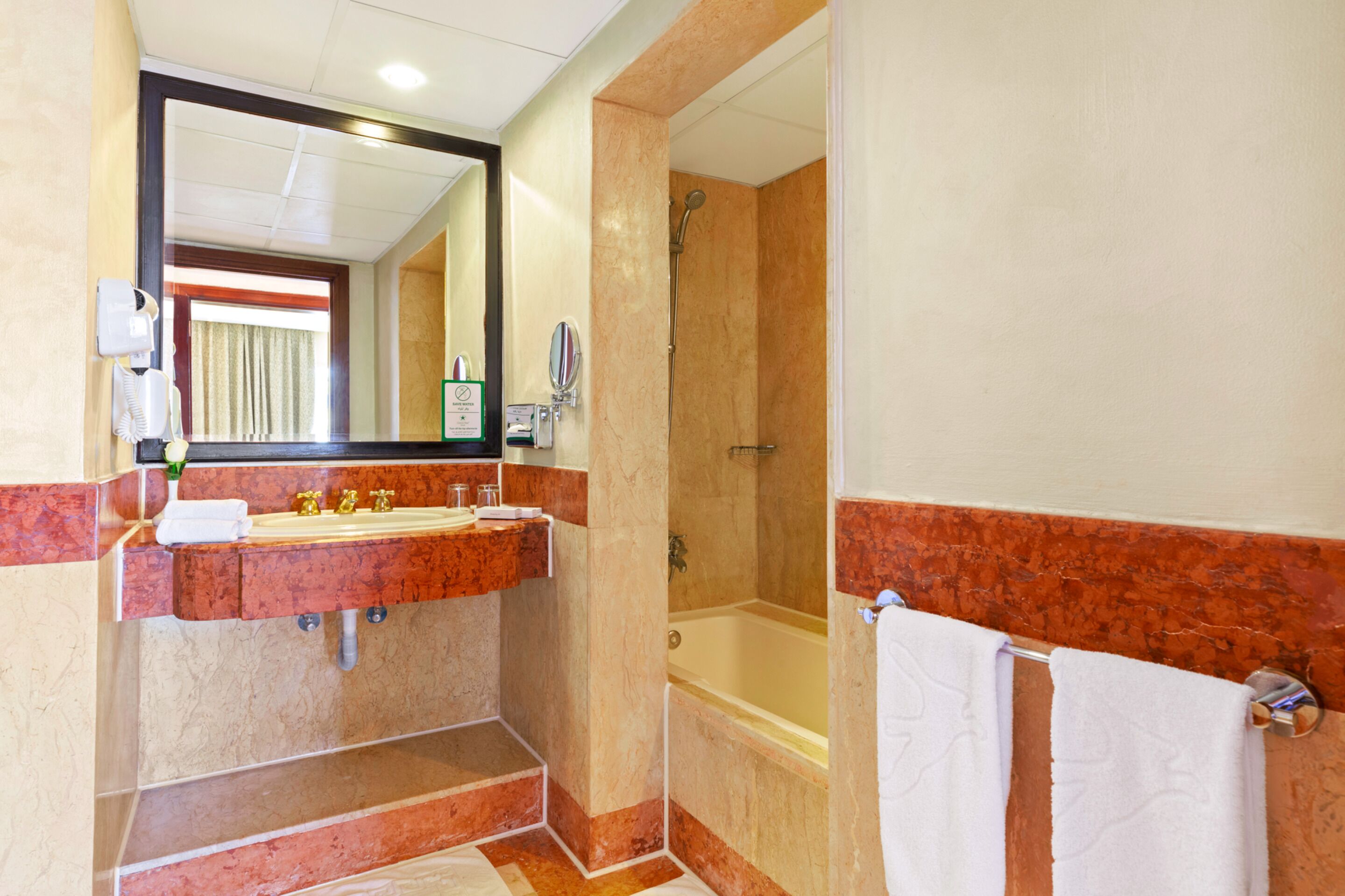 Une salle de bain avec un lavabo, un miroir et une douche.