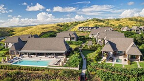 A resort with multiple buildings, a swimming pool, and a well-maintained garden. - InterContinental Fiji Golf Resort & Spa by IHG (Natadola)