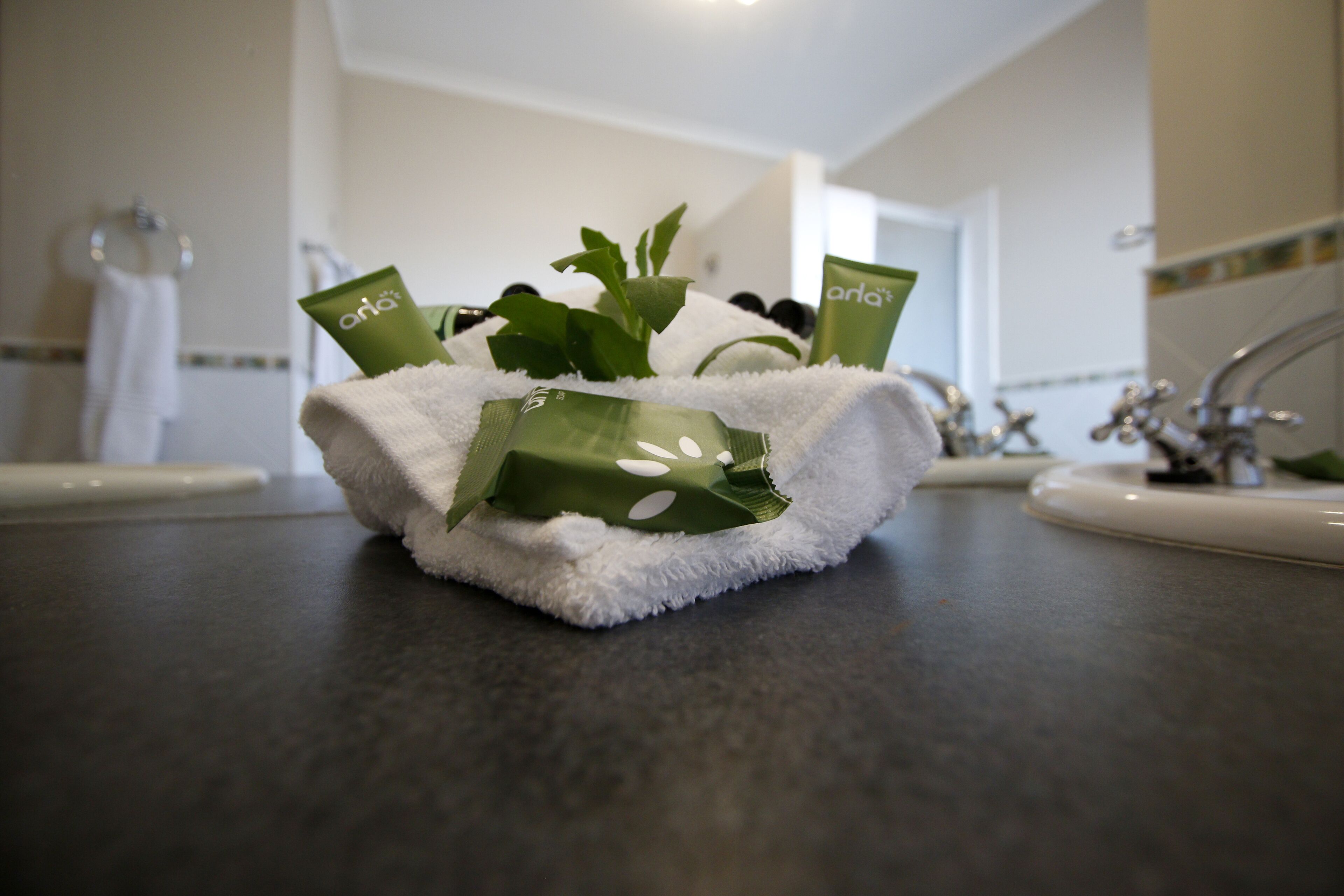A bathroom sink area with a towel and toiletries.