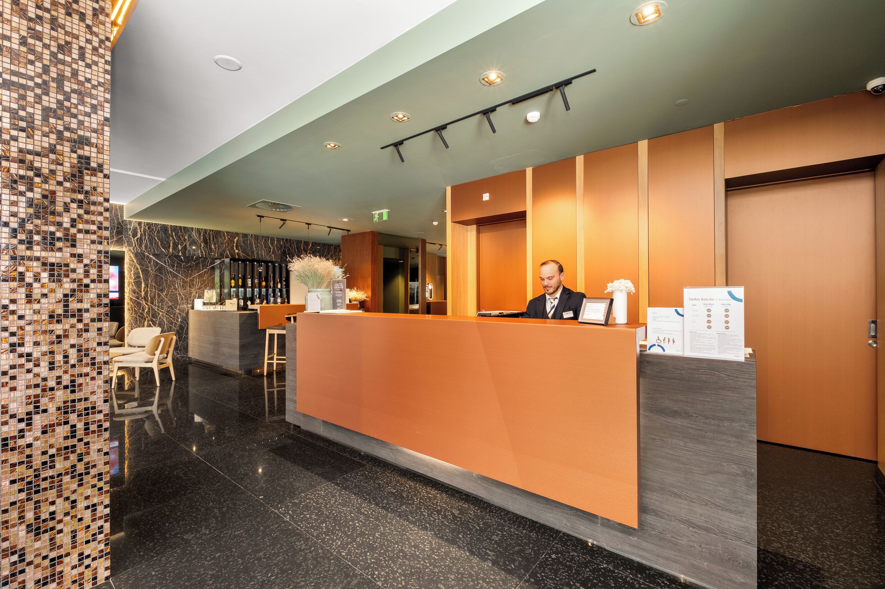 A reception desk with a receptionist, a check-in counter, and a seating area with chairs.