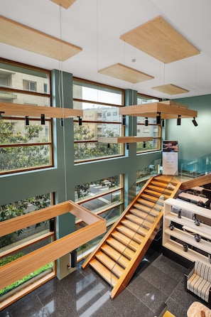 A multi-level interior with glass railings, wooden beams, and a staircase. - Axis Porto Business & Spa Hotel (Matosinhos)